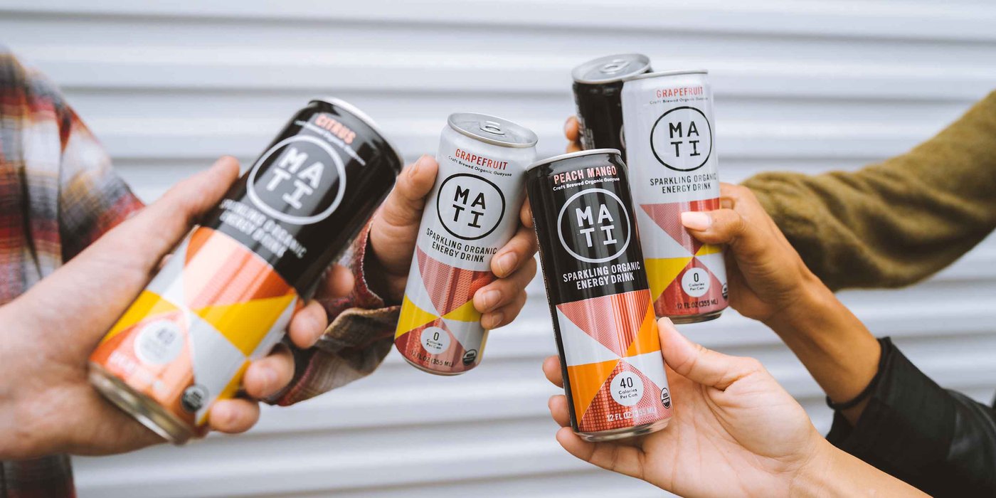 Multiple people cheering with MATI Energy citrus, Peach Mango, and Grapefruit