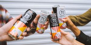 Multiple people cheering with MATI Energy citrus, Peach Mango, and Grapefruit